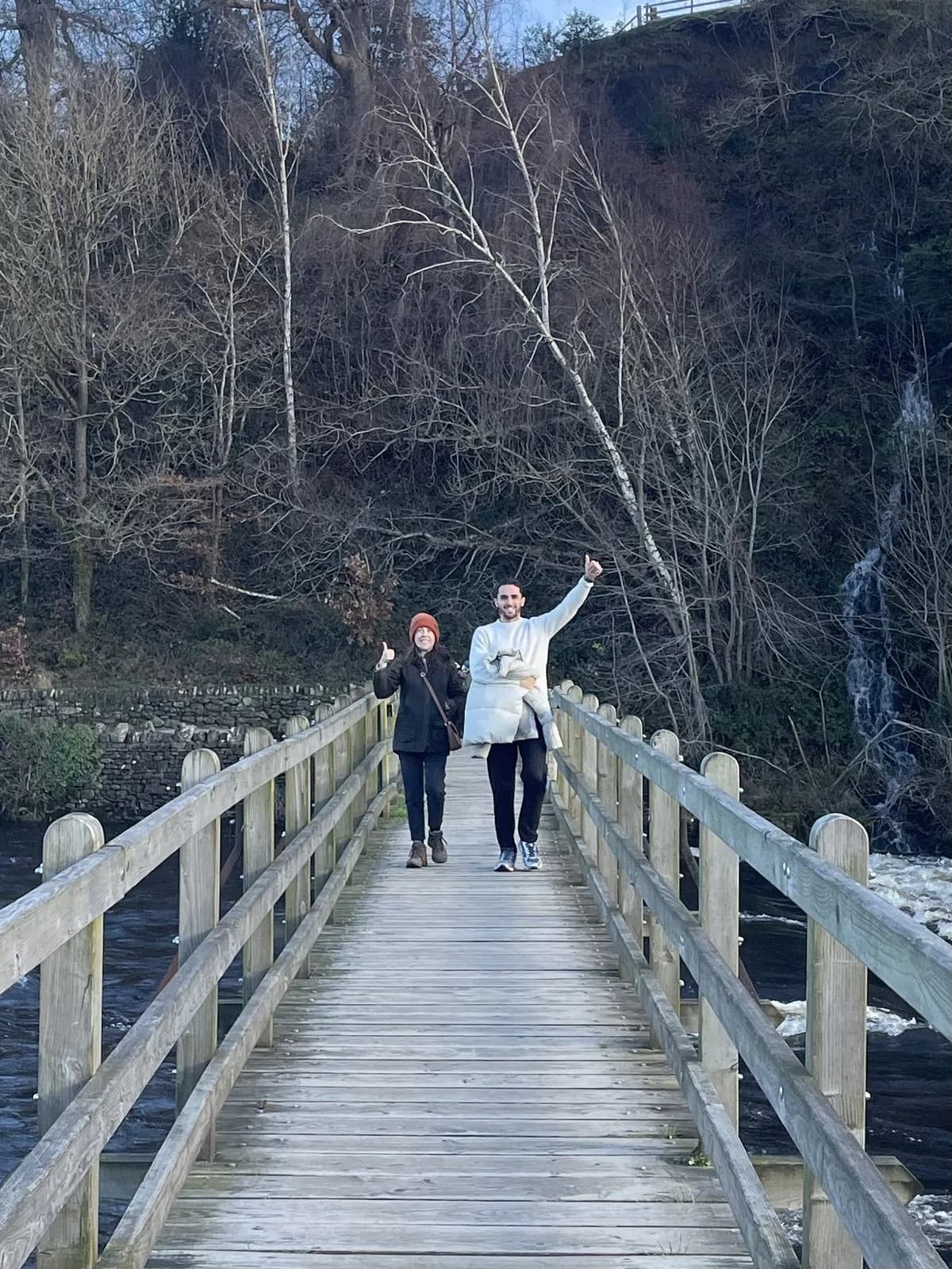 Mike McDonnell and Dawn of Aireside Accounting waving from a footbridge on a countryside walk