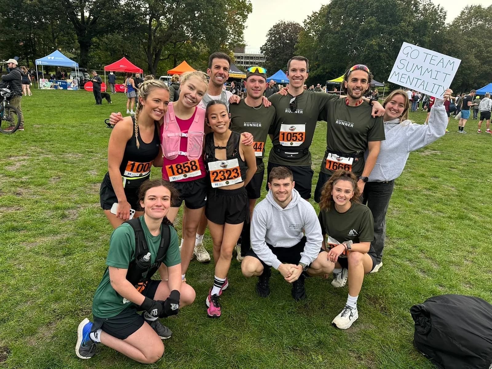 The Summit Mentality run club group with race numbers on after an event